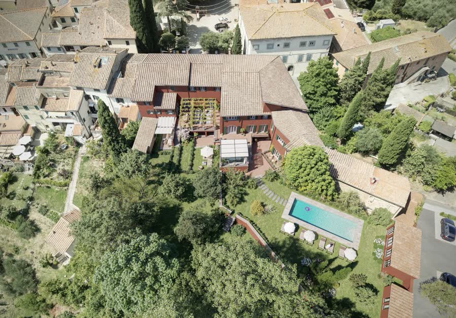 Aerial view of the building, park and pool